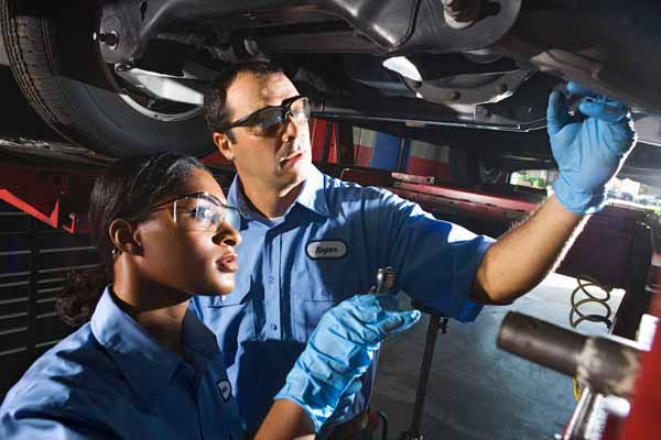 Mechanics working under car